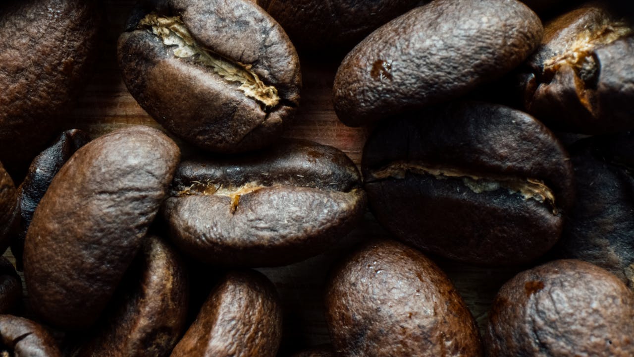 Detailed close-up of aromatic roasted coffee beans highlighting texture and richness.